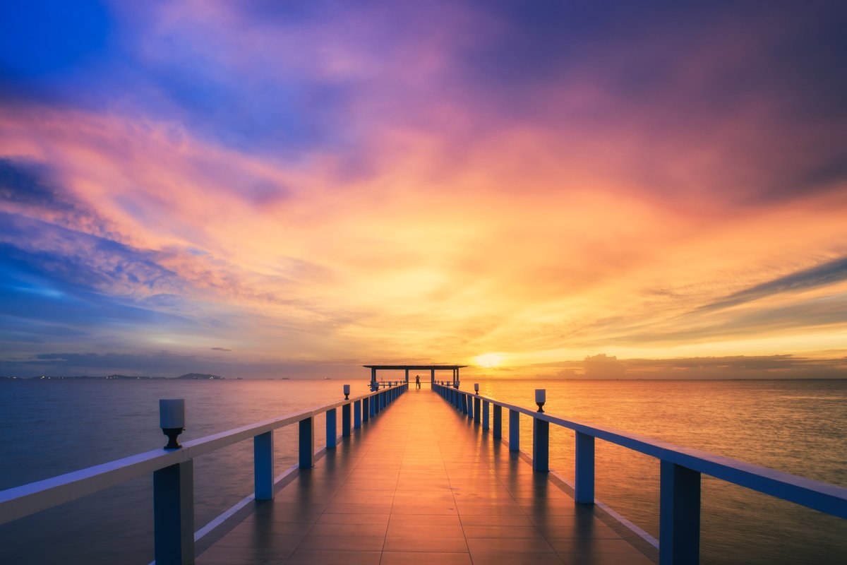 The pier scene with a moody, cinematic teal-and-gold grade and richer contrast.