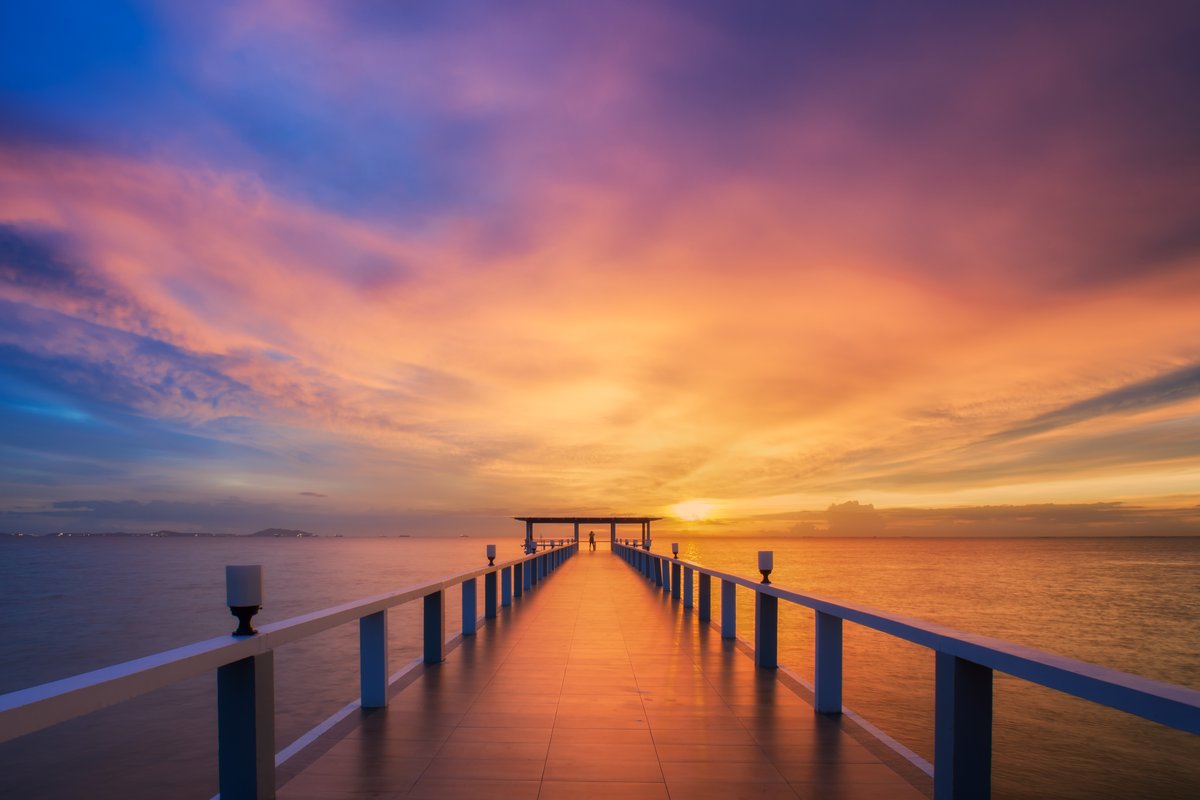 A sunset over a wooden pier, straight out of camera.