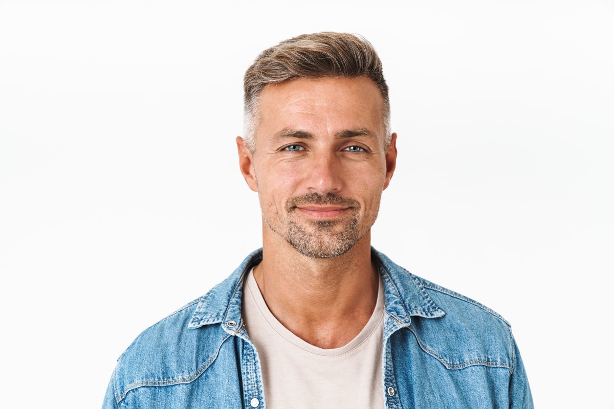 A neutral studio portrait of a man on a white background.